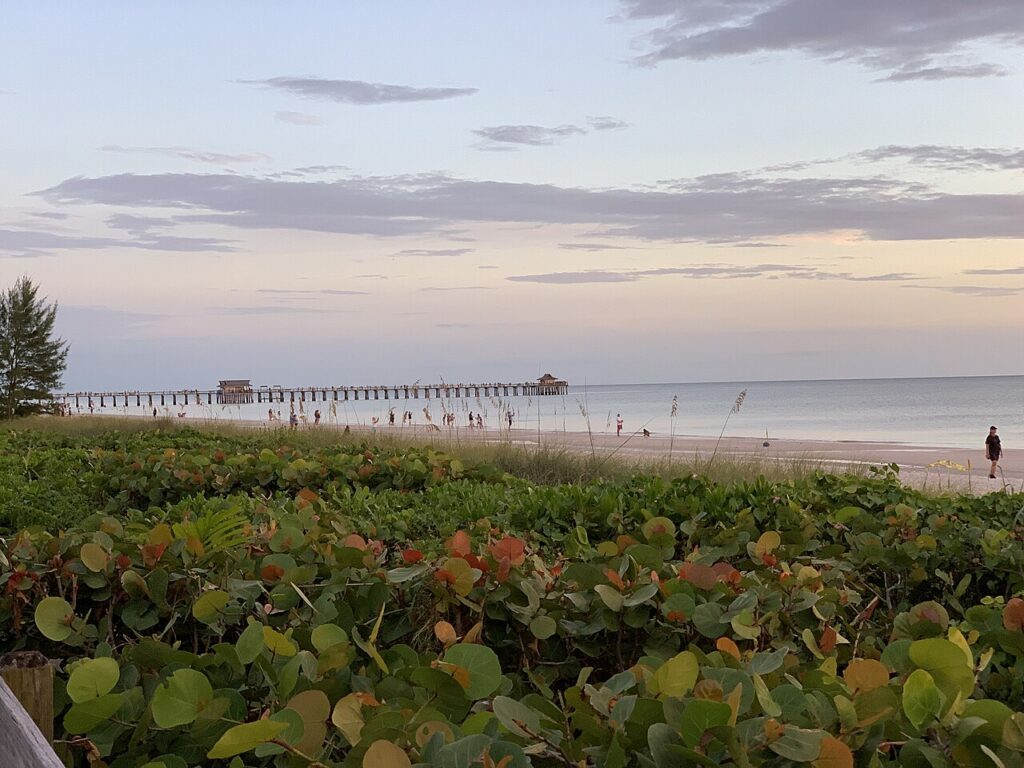 Naples Pier visto da praia ao pôr do sol na Flórida